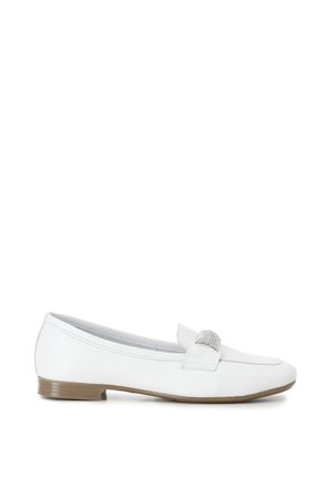 Mocasín plano de piel blanca con tacón bajo marrón y hebilla adornada con brillantes en el empeine.