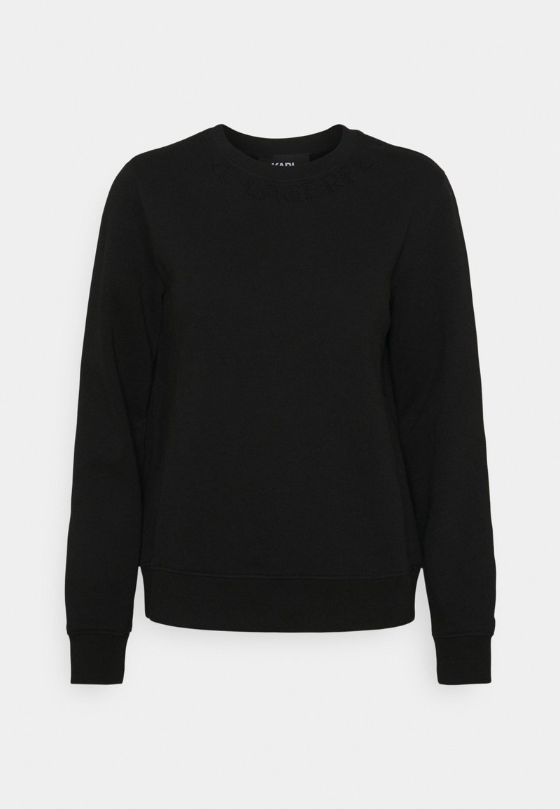 Sweat-shirt noir à manches longues avec col rond, poignets et ourlet côtelés, présenté sur un fond gris clair uni.