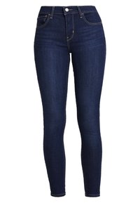 Vaqueros ajustados de color azul oscuro hechos de mezclilla. Diseño de cintura alta con una textura suave y detalles de costura sutiles. Sin desgastes visibles.
