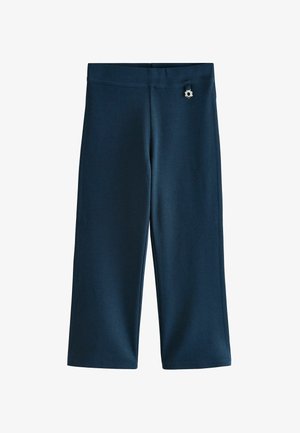 Pantalons larges bleu marine en tissu lisse, dotés d'une taille plate et d'un charm en métal en forme de fleur décoratif à l'avant.