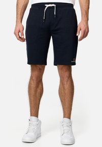 Mørkeblå sweat shorts med snoretræk i taljen, sidelommer og lille logo broderi. Glat bomuldsstof med en afslappet pasform.
