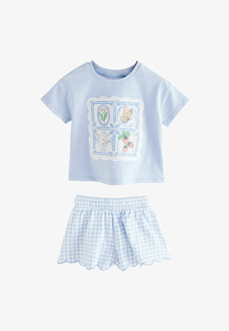 Light blue children’s outfit with a short-sleeve top featuring flower, butterfly, bird, and strawberry prints, paired with checkered scalloped shorts.