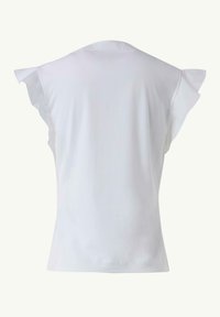 White short-sleeve top with ruffle accents on shoulders, made of soft, stretchy fabric, featuring a smooth texture and rounded neckline.