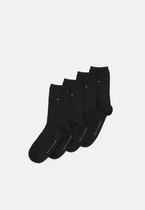 Black cotton socks set of four, featuring a small tri-color logo on each sock and a logo print along the cuff. Smooth texture, ankle-length design.