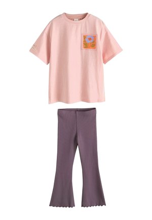 Pink short-sleeve t-shirt with floral square patch on chest paired with purple flared leggings with lettuce hem.
