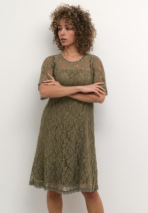 Lace dress in olive green, featuring short sleeves, scalloped neckline, and a flared silhouette with intricate floral patterns.