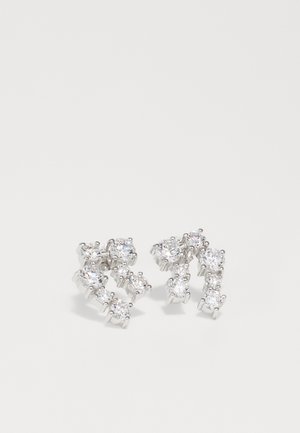 Silver earrings featuring a twisting design set with multiple clear gemstones of varying sizes, showcasing a high-shine finish.