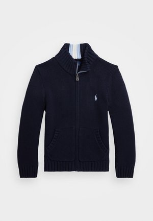 Navy knitted cardigan with a high collar, zip closure, two front pockets, and ribbed cuffs, featuring a small logo on the left chest.