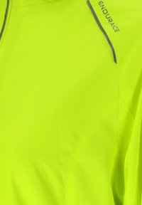 Fluorescent yellow athletic jacket with a smooth texture, featuring a zippered front and "ENDURANCE" logo in dark blue on the shoulder.