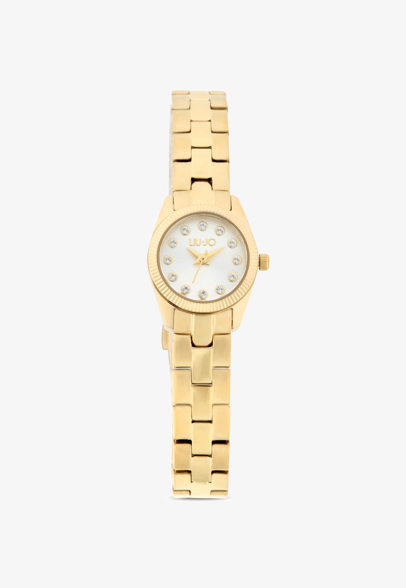Orologio in tono oro con bracciale a maglie, quadrante bianco, 12 marcatori dell'ora in cristallo e una lunetta testurizzata. Presenta una corona sul lato.
