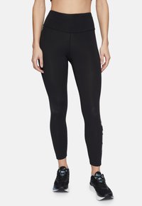 Svarta leggings med hög midja, mjuk textur och en åtsittande design, kompletterad med logodetaljer längs sidan.