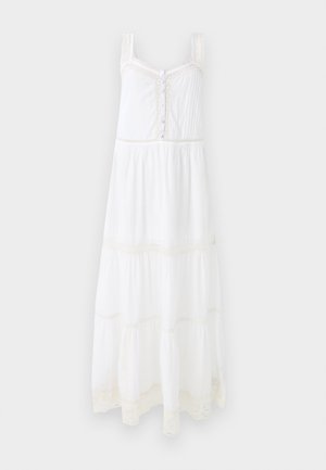 White maxi dress with adjustable straps, lace trim, button detailing, and tiered ruffles. Made of lightweight fabric with a soft texture.