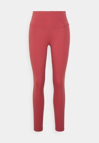 Leggings a vita alta di un colore ruggine uniforme, realizzati in tessuto elastico con una texture liscia e un design aderente, che si restringe alla caviglia.