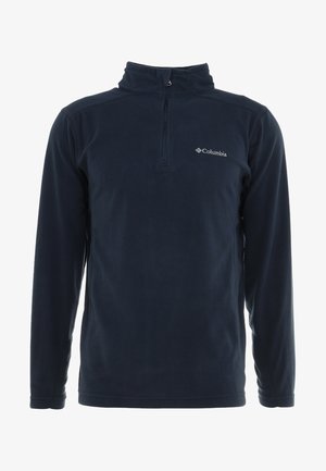 Marineblå fleecepullover med halv-zip krave, lange ærmer og et diskret logo på venstre bryst. Blød tekstur, let design.