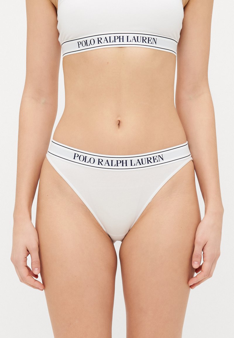 White cotton thong with a fitted design. Features a contrasting branded elastic waistband with "POLO RALPH LAUREN" text in navy.