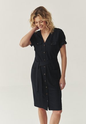 Navy button-up dress with short sleeves, two chest pockets, belted waist, and a straight cut, made from lightweight fabric.