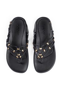 Black sandals featuring woven straps with gold accents, a smooth textured footbed, and a flat sole design.