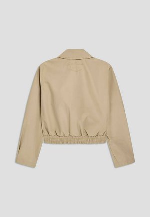 Giacca cropped beige con maniche lunghe, cintura elastica in vita e colletto, vista da dietro su sfondo uniforme.