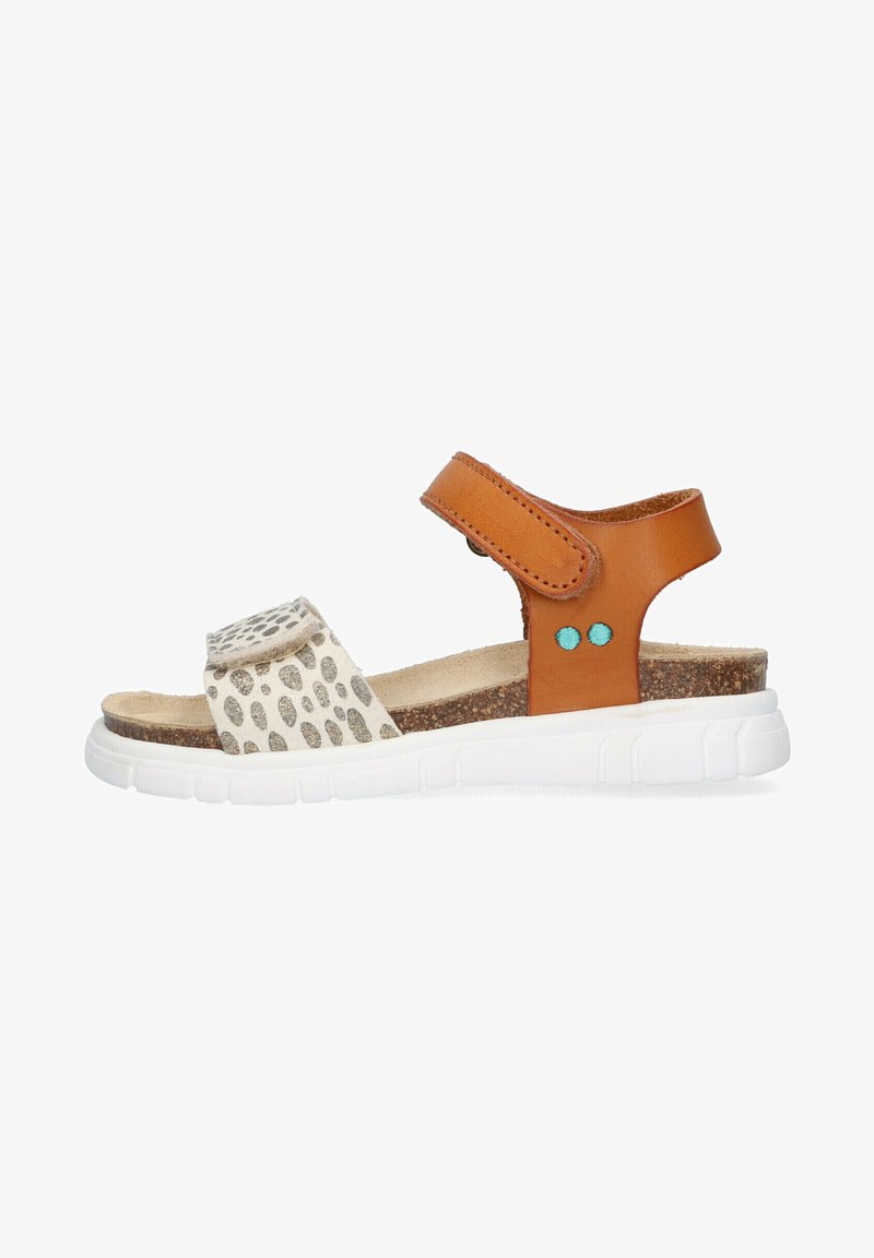 Tan leather sandal with a textured cream strap featuring silver dots, white rubber sole, adjustable buckle, and blue accents.