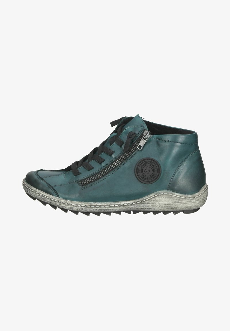 Botas de tobillo de piel verde azulado con cordones negros, cremallera lateral, suela texturizada gris y parche de logo redondo. Presentan un diseño aerodinámico y deportivo.
