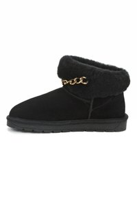 Schwarze Wildleder-Stiefeletten mit einem flauschigen schwarzen Fellbund und goldenen Kettendetails. Flache schwarze Gummisohle und genähte Designs an den Seiten.