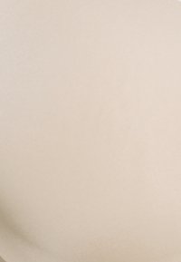 Beige, smooth fabric with a subtle sheen, curved shape, and slight texture. No prominent patterns or details are visible.