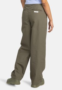 Olive green, lightweight fabric trousers with a relaxed fit, featuring back pockets and a brand tag above the right pocket.