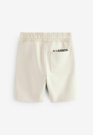 Lys beige bomuldsbukser med elastisk talje, der har en baglomme og sort "ALLSAINTS" logo på siden. Glat tekstur.