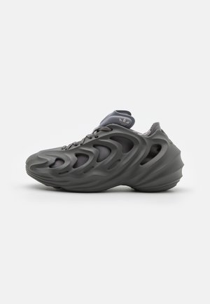 Gray athletic shoe featuring a sculpted design with prominent cut-out sections, textured upper, and a cushioned sole.