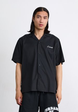 Black short-sleeve button-up shirt with a camp collar, made of smooth fabric, featuring white embroidery of the brand name on the left chest.