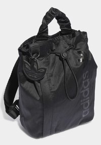 Black drawstring bag made of textured nylon, featuring a logo print, a detachable keychain, and short fabric handles.