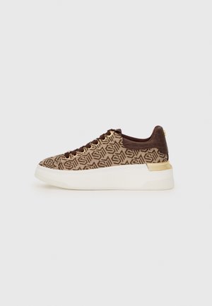 Lace-up sneakers in brown and beige fabric featuring a geometric pattern, a textured brown heel, and a white platform sole with gold accents.