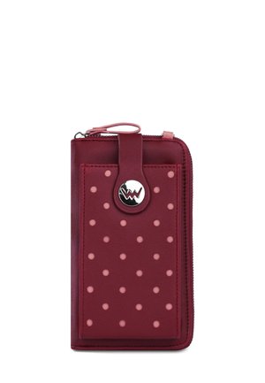 Red leather wallet with pink polka dots, zipper closure, and a silver button with a "W" logo on front strap.