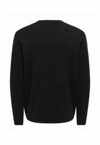 Pull en maille noir à manches longues, vu de dos avec un col rond et un ourlet droit.