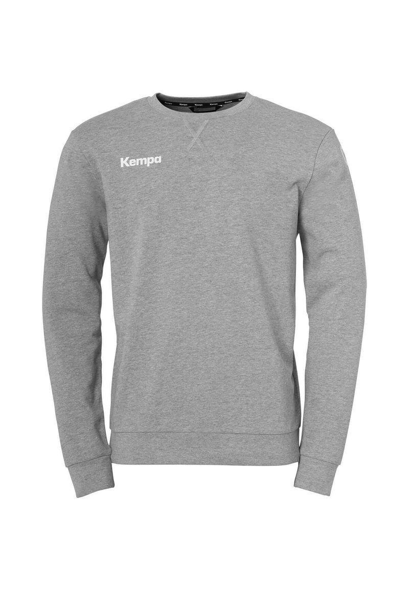 Grijze sweatshirt met lange mouwen, ronde hals en geribde manchetten. Heeft een wit "Kempa"-logo aan de bovenlinkerkant. Zachte textuur.
