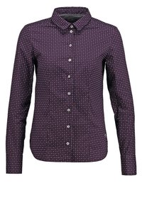Chemise à manches longues boutonnée de couleur violet foncé avec un petit motif géométrique. Caractéristiques : un col pointu et un ourlet arrondi. Boutons sur le devant central.