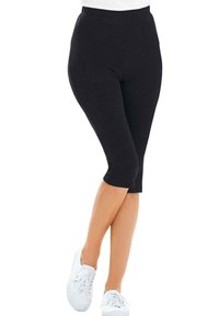 Zwarte leggings in een strakke pasvorm met een elastische tailleband, met een lengte tot halverwege de kuit en een gladde, rekbare stof voor comfort.