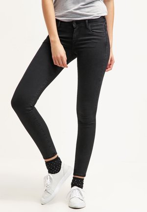 Jeans skinny negros confeccionados en denim, que cuentan con un diseño estándar de cinco bolsillos, un cierre frontal con botón y una textura suave.