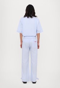 Fiorucci STRIPED LOGO TROUSERS UNISEX - Kelnės - light blue