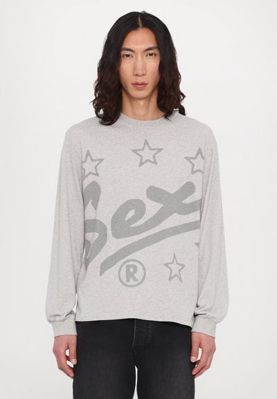 Gray long-sleeve t-shirt featuring large dark gray text and stars. Made from soft fabric with a relaxed fit and ribbed cuffs.