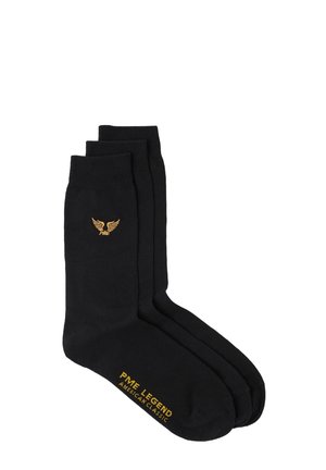 Chaussettes en coton noir dans un pack de trois, avec un logo en forme d'aile dorée et le texte "PME LEGEND AMERICAN CLASSIC" en or sur le côté.
