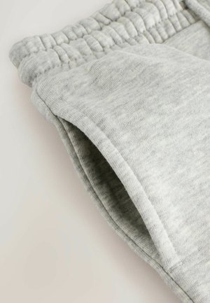 Lysegrå sweatpants med en blød tekstur, der har en elastisk talje og en sidelomme, let smalnet ved anklen.