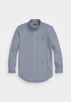 Marineblauw en witte geruite overhemd met lange mouwen, knoopsluiting, afgeronde zoom en geborduurd logo op de linkerborst. Gemaakt van katoen.