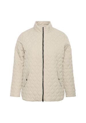Veste matelassée beige avec col montant, fermeture éclair frontale et poches latérales. Présente des coutures géométriques et des accents de fermeture éclair noirs.