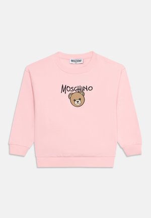 Sweat-shirt rose à manches longues avec poignets et ourlet côtelés, avec un visage d'ours en peluche et le nom de la marque Moschino sur le devant.