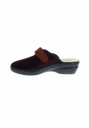 Zapatilla cerrada en negro y rojo oscuro tipo slip-on con una correa marrón ajustable y una suela cuña baja negra.