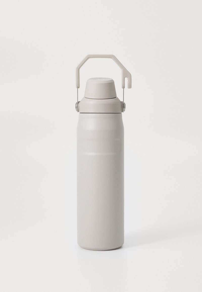 Stainless steel insulated water bottle with a matte beige finish, cylindrical shape, and a hinged carrying handle.