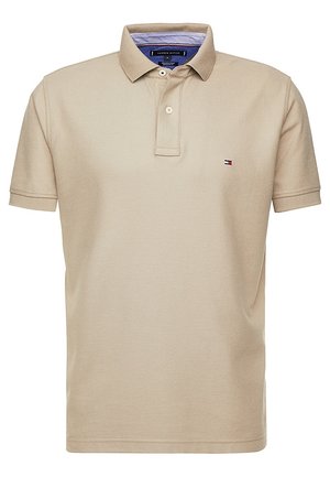 Beige short-sleeve polo shirt with two buttons, small Tommy Hilfiger logo on the left chest, and striped inner collar detail.