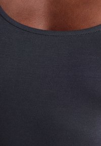 Black, fitted tank top featuring a rounded neckline, made of smooth, lightweight fabric with subtle ribbing texture.