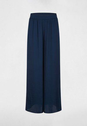 Marineblå bukser med vide ben og elastik i taljen, lavet af let stof, vist fladt mod en hvid baggrund.